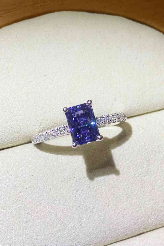 a fancy ring with a blue sapphire surrounded by diamonds