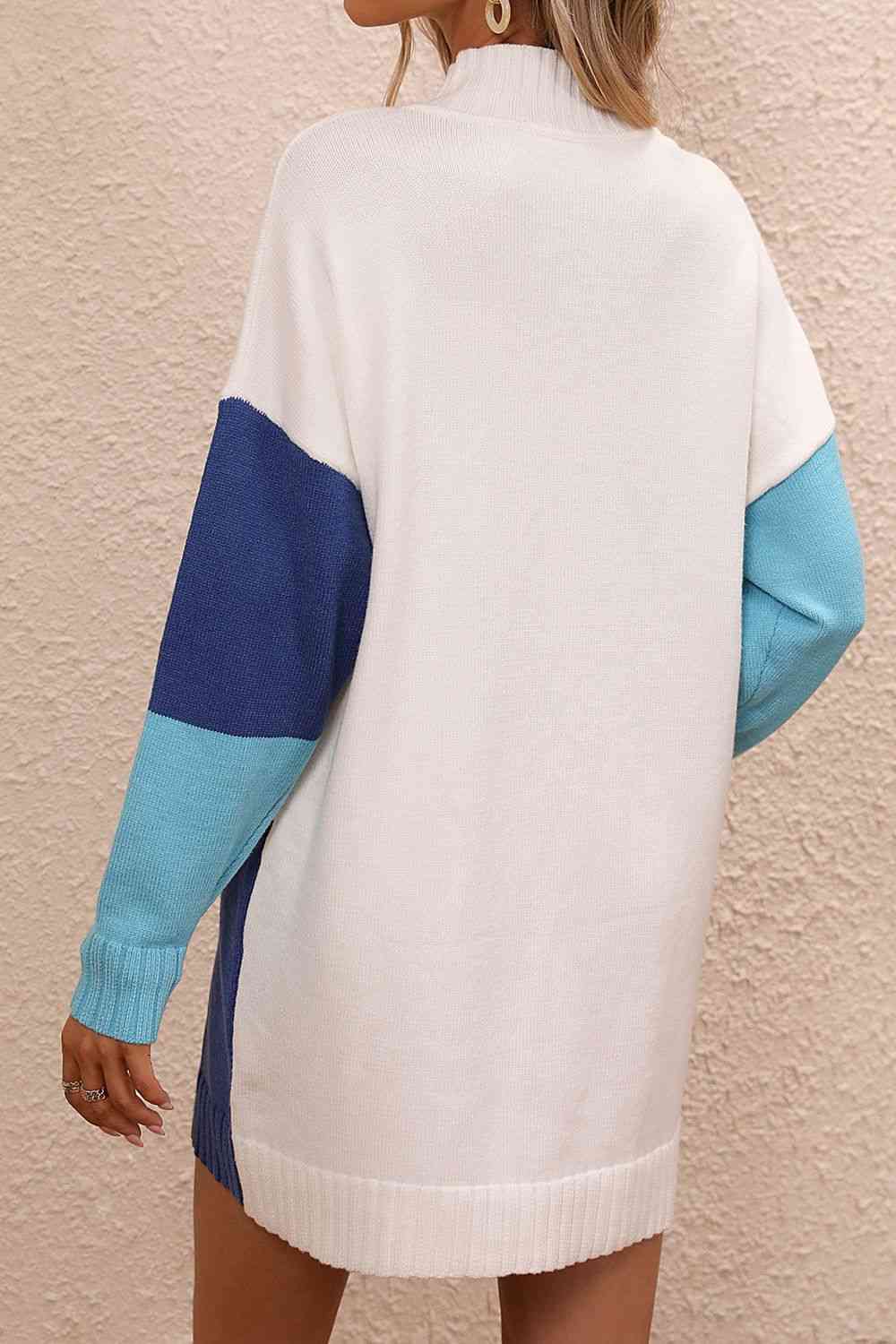 a woman wearing a white and blue sweater