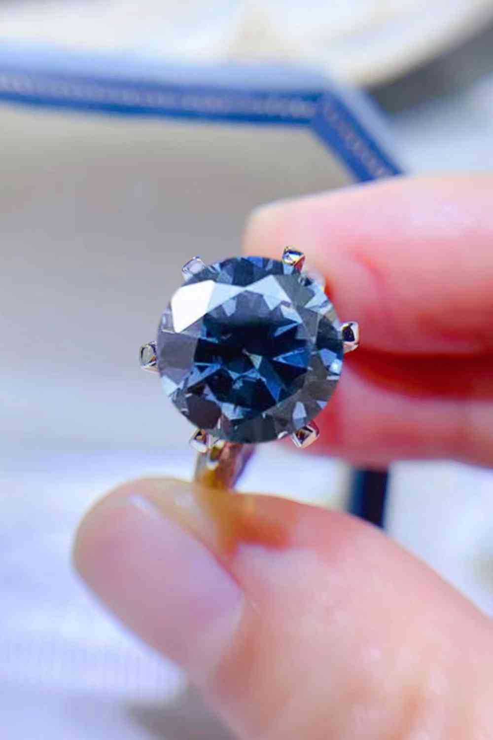 a person holding a blue diamond in their hand