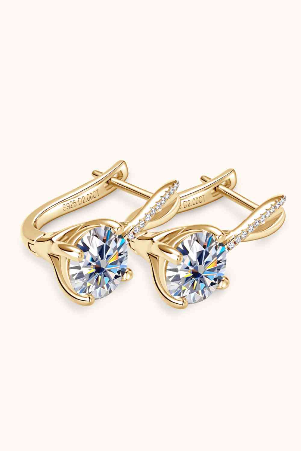 a pair of gold tone earrings with crystal stones