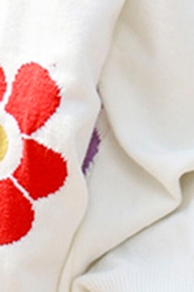 a close up of a white shirt with a red flower on it