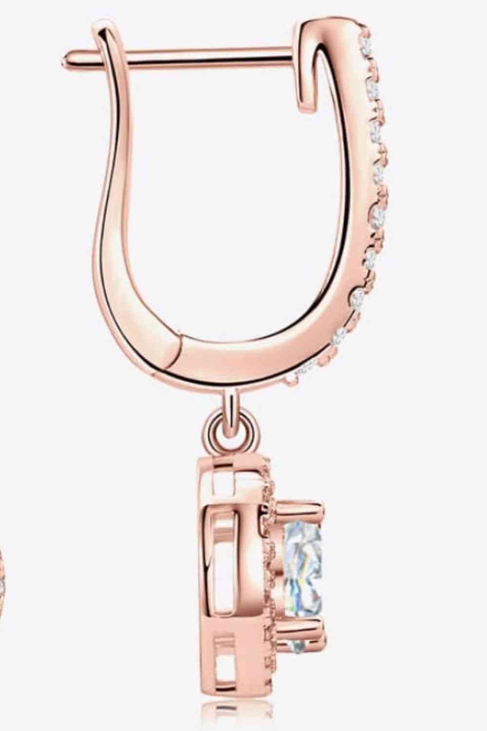 a pair of rose gold hoop earrings with cubics