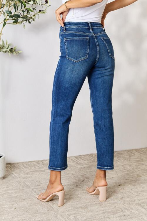a woman wearing high rise jeans and heels