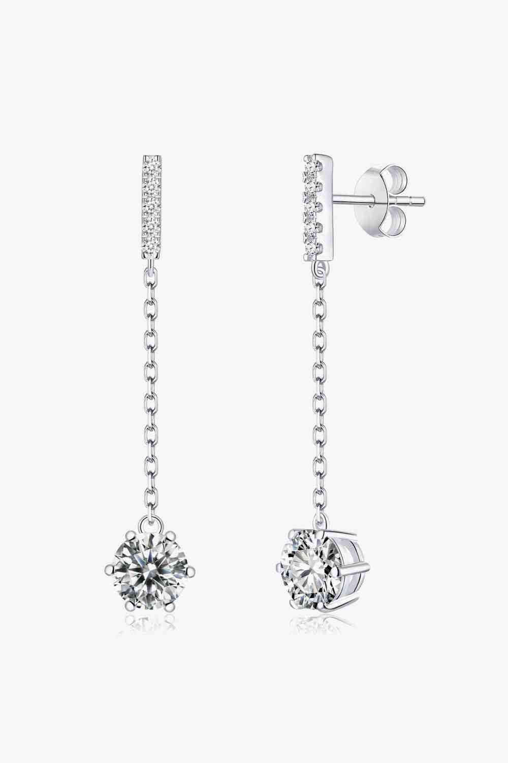 a pair of white gold earrings with a diamond