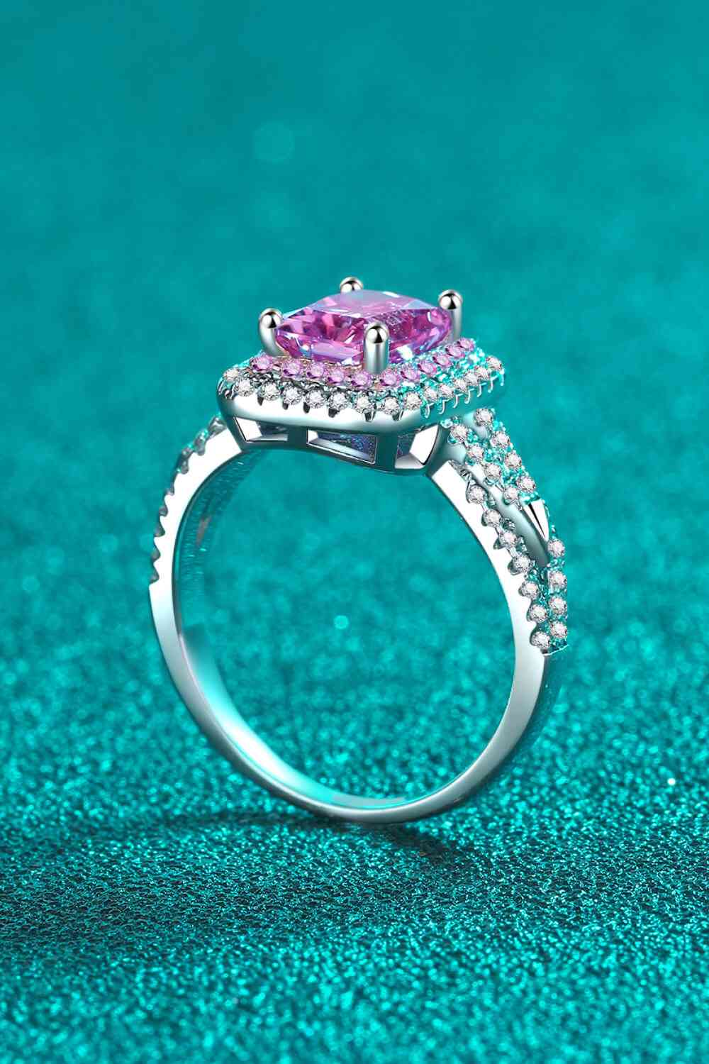 a pink diamond ring on a blue background