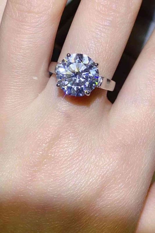 a close up of a person's hand with a ring on it