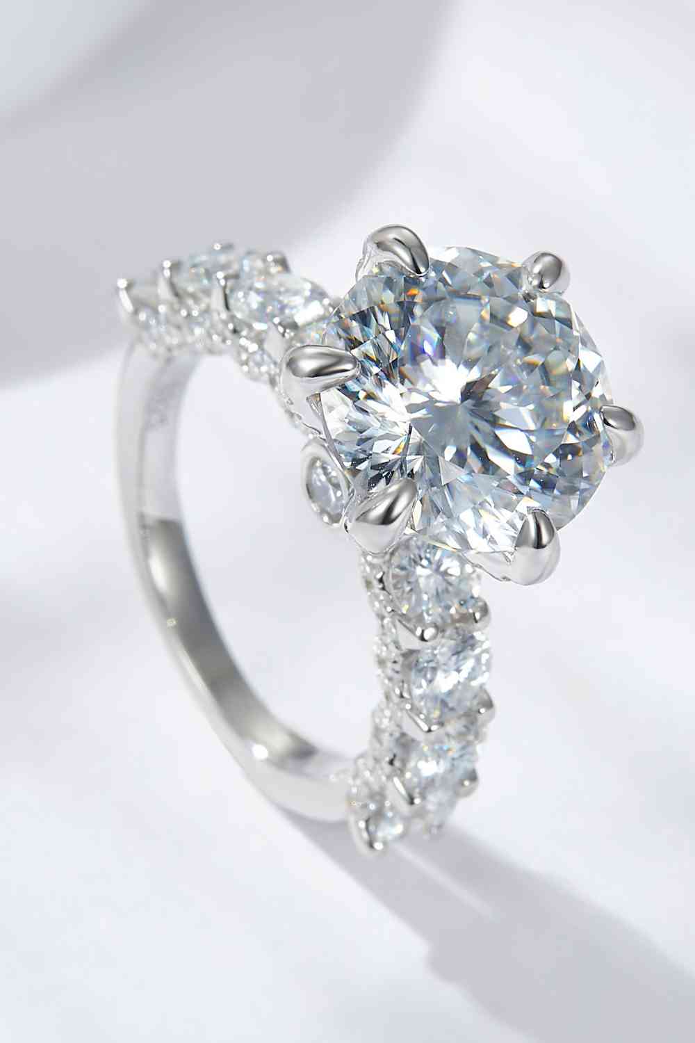 a diamond ring with three stones on top of it