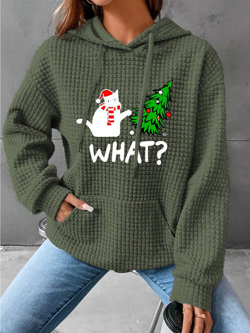 a woman wearing a green sweater with a christmas tree on it