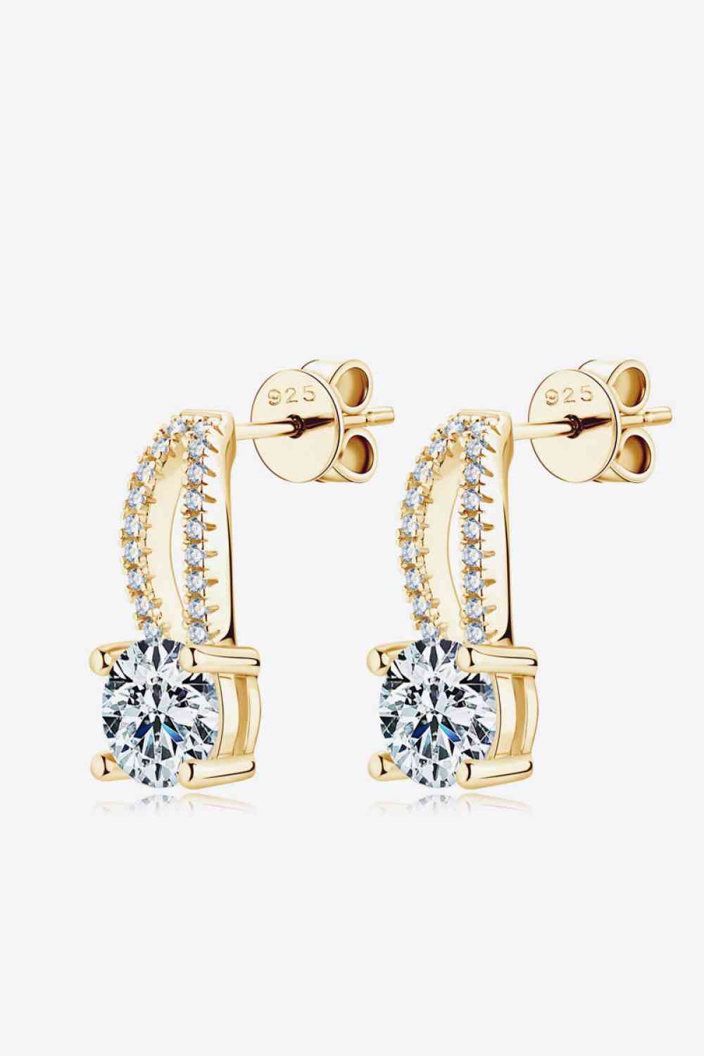 a pair of gold earrings with a cubic stone
