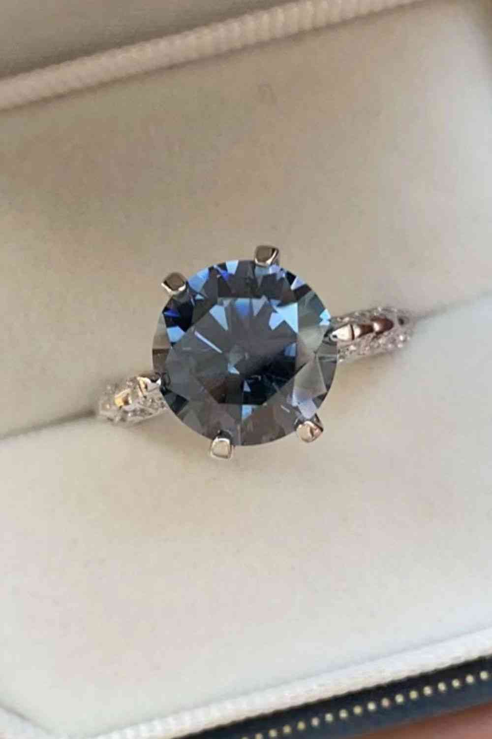 a ring with a blue stone in a box