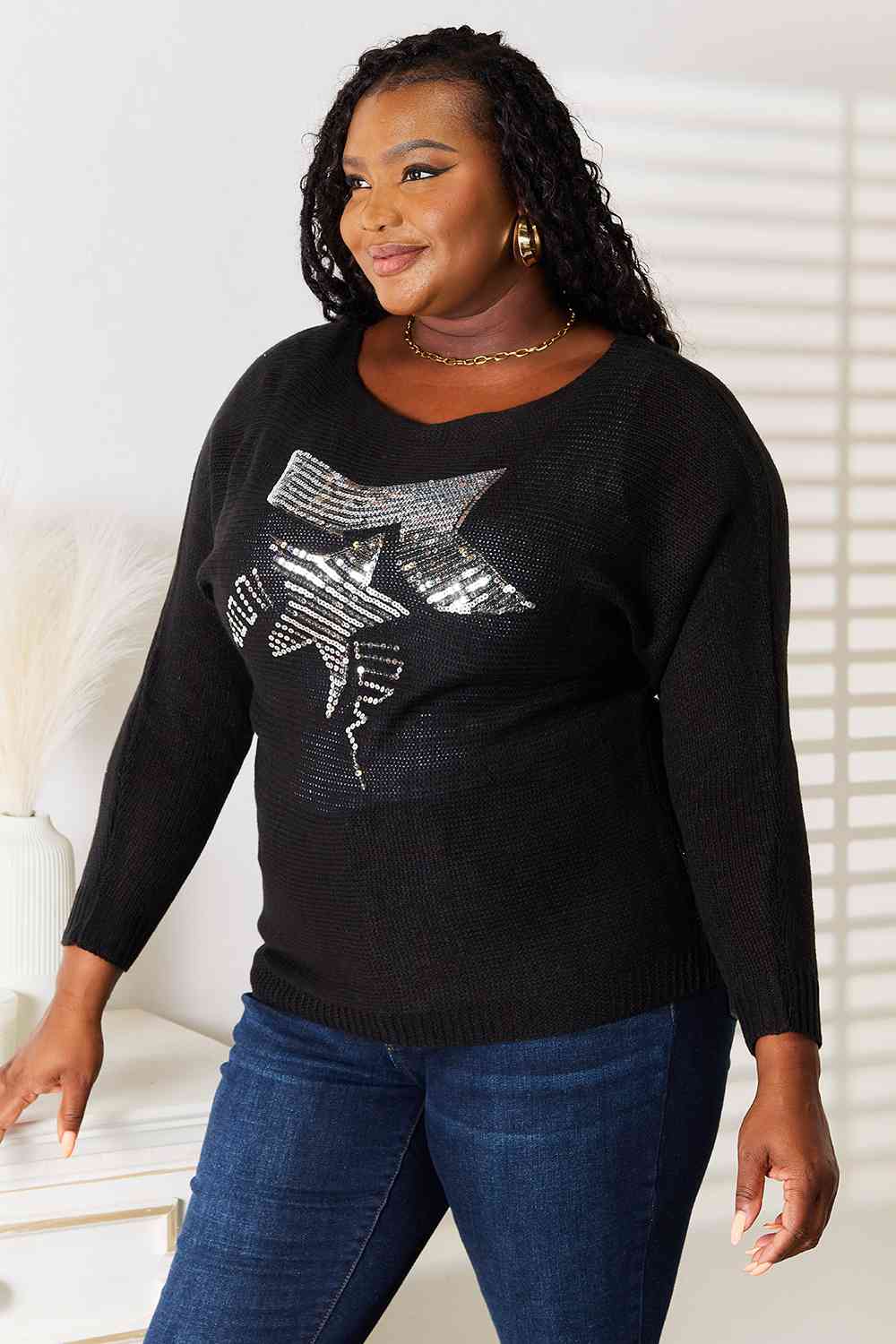 a woman wearing a black sweater and jeans
