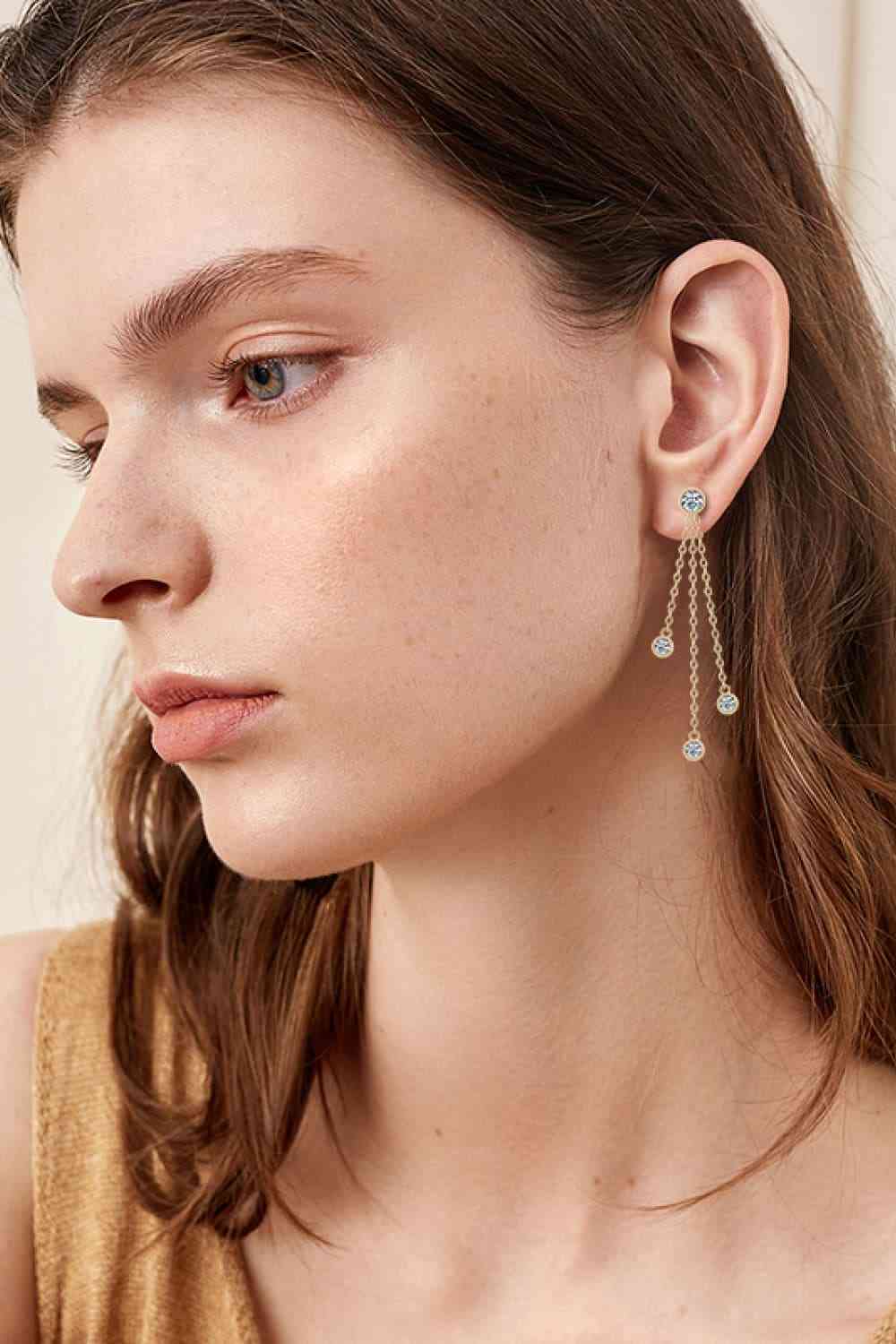 a woman wearing a pair of earrings