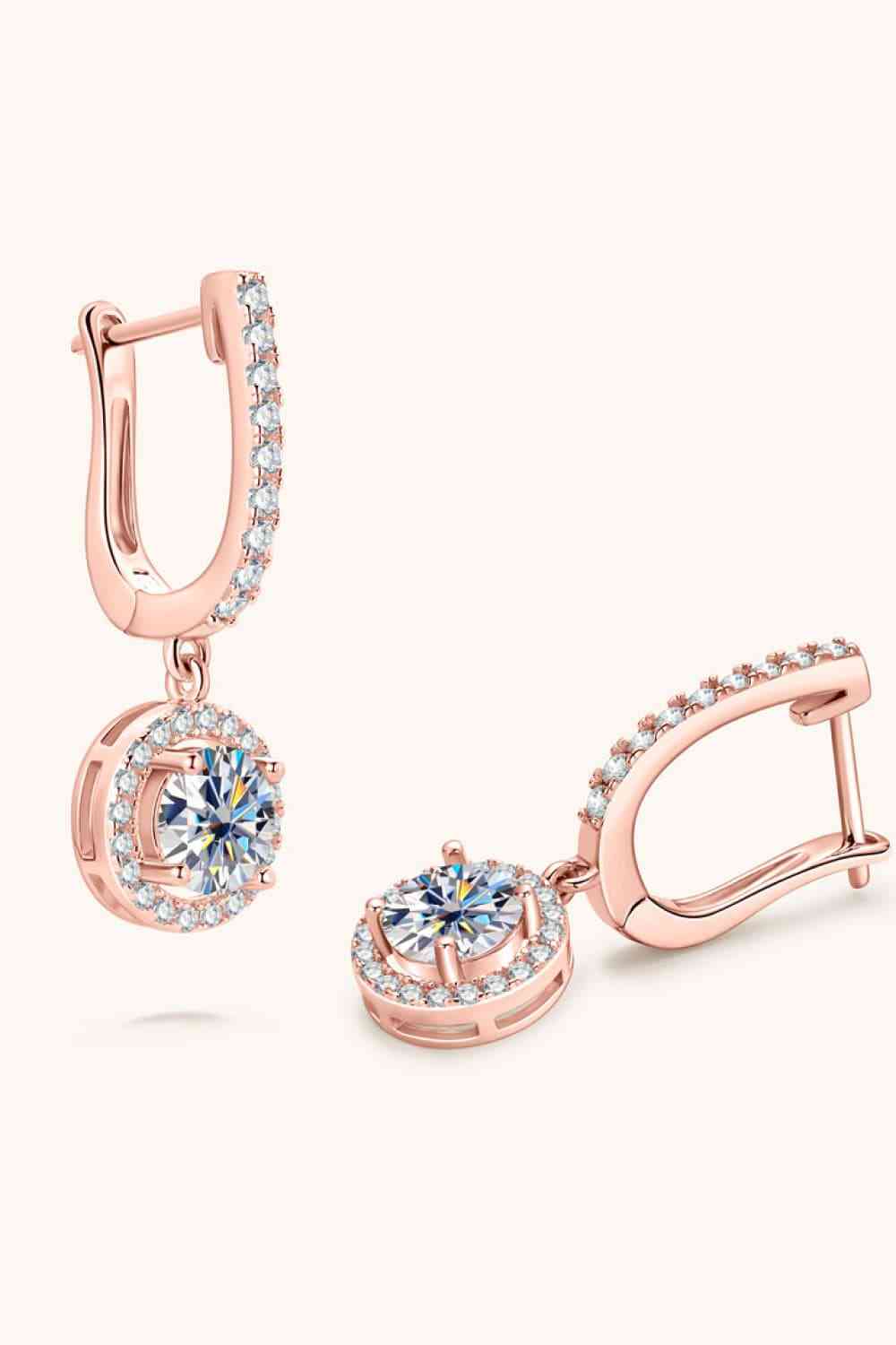 a pair of rose gold earrings with diamonds