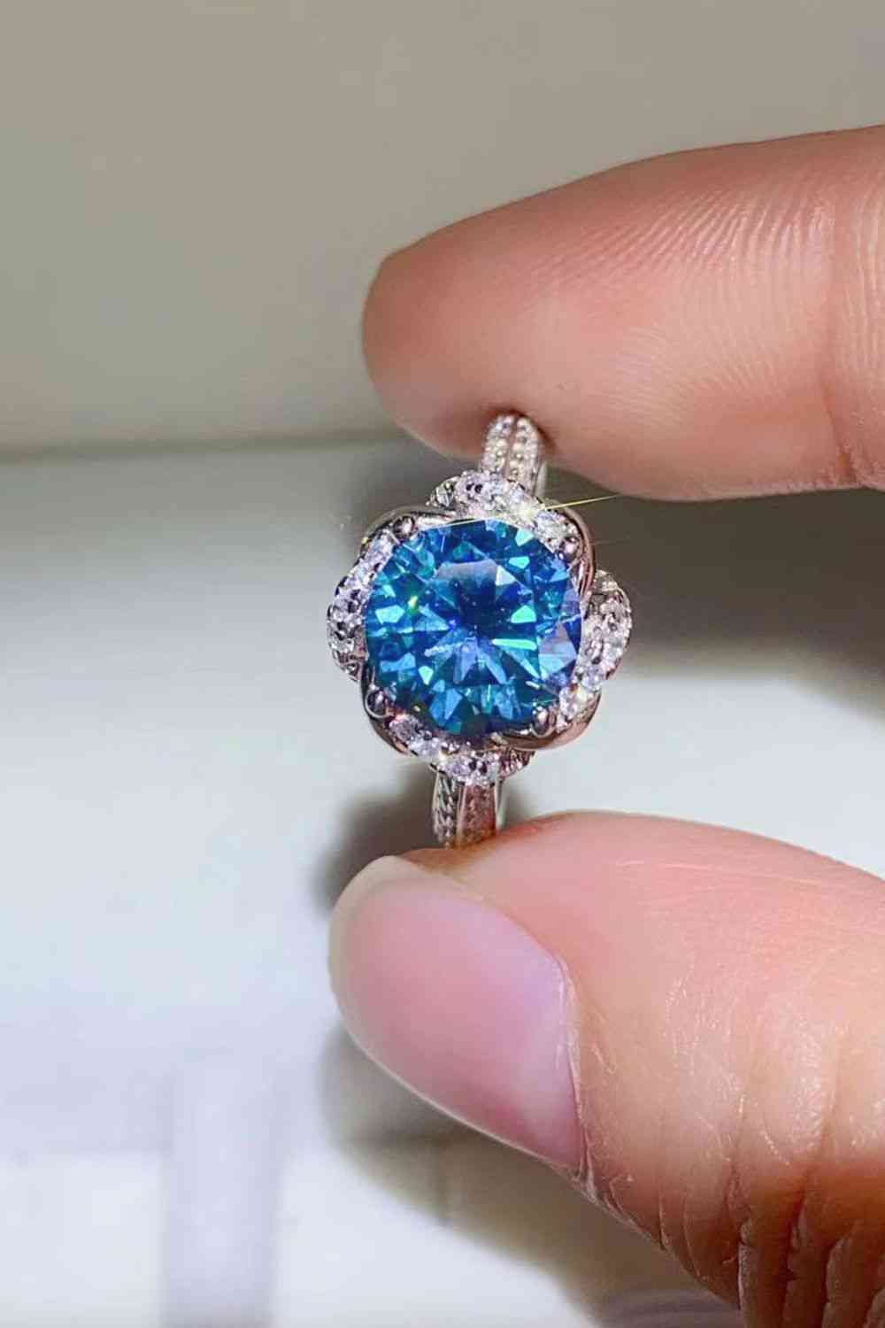 a person holding a blue ring in their hand