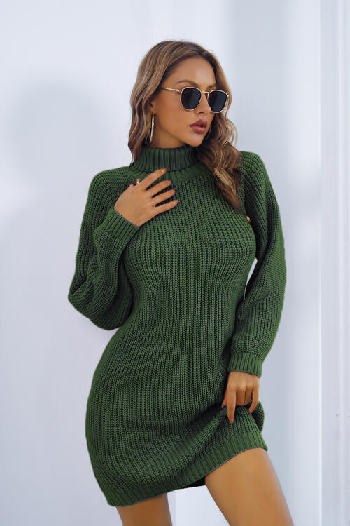 a woman wearing a green turtle neck sweater dress