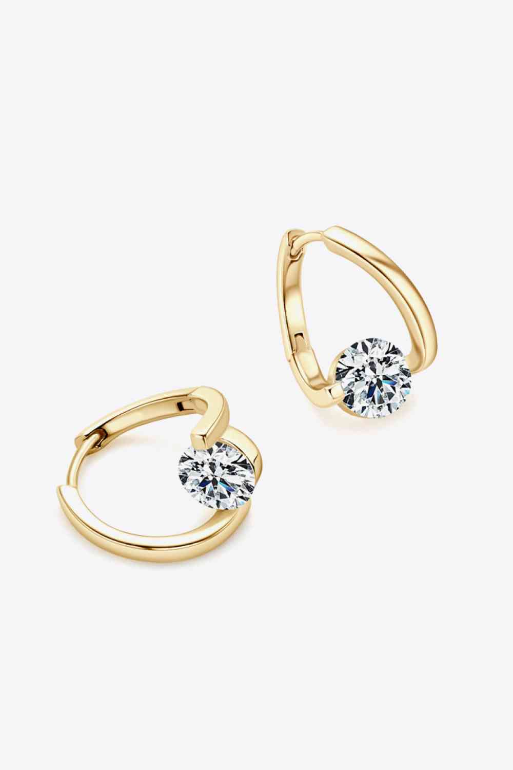 a pair of gold hoop earrings with a diamond