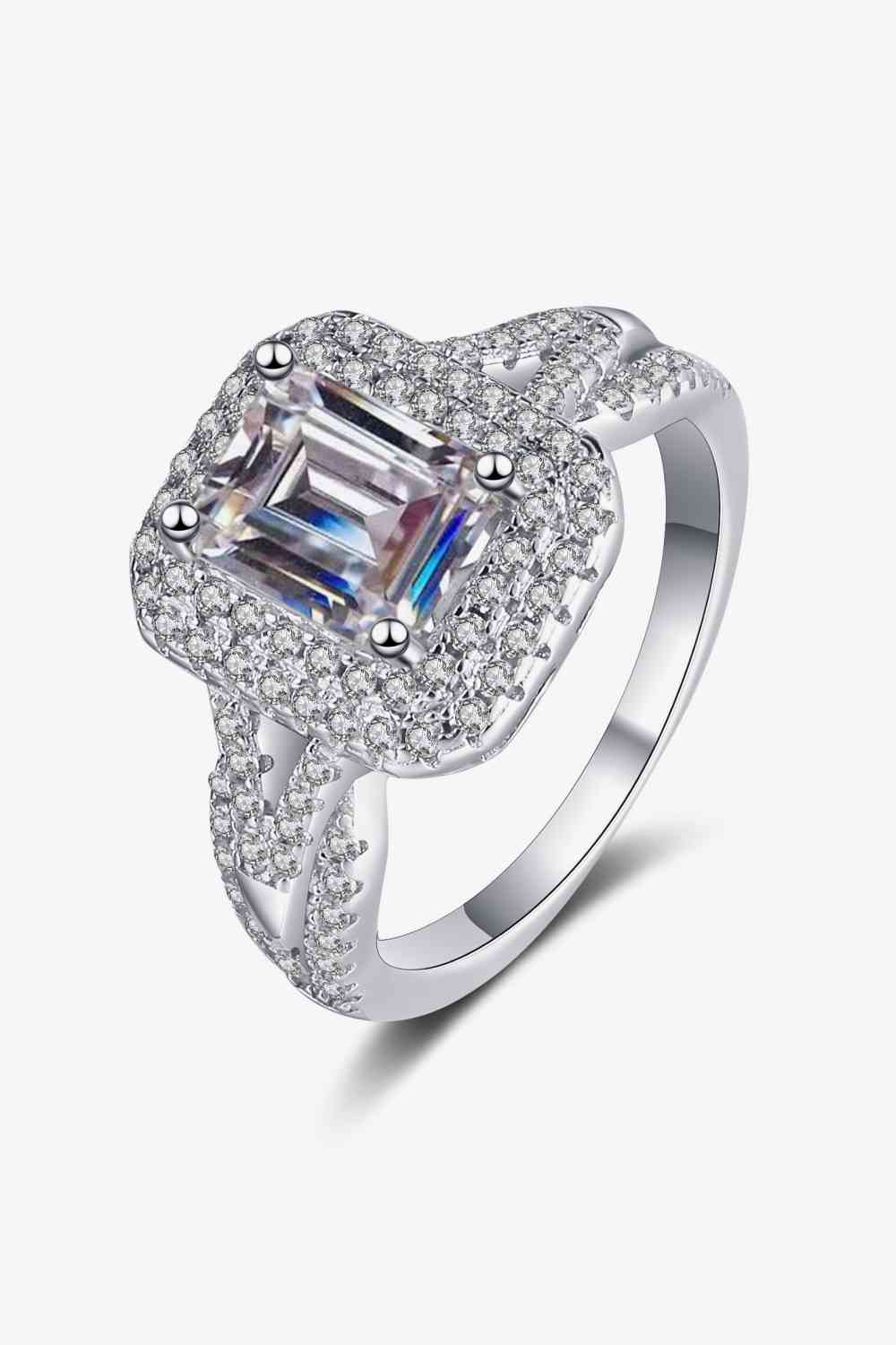 a white gold ring with a square cut diamond surrounded by diamonds