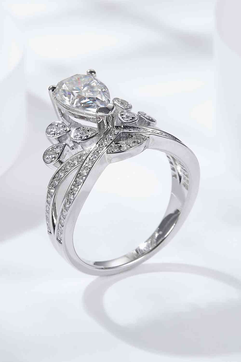 a white gold ring with a pear shaped diamond