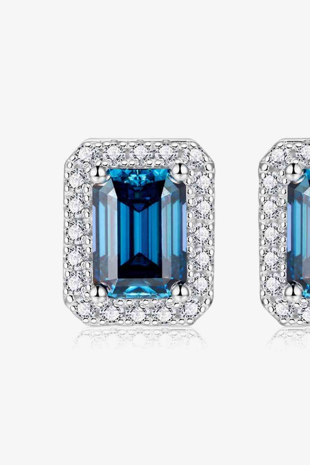 a pair of blue and white diamond earrings