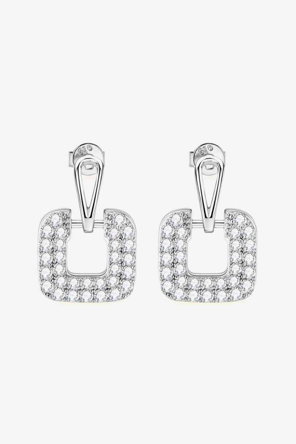 a pair of earrings with square shaped diamonds