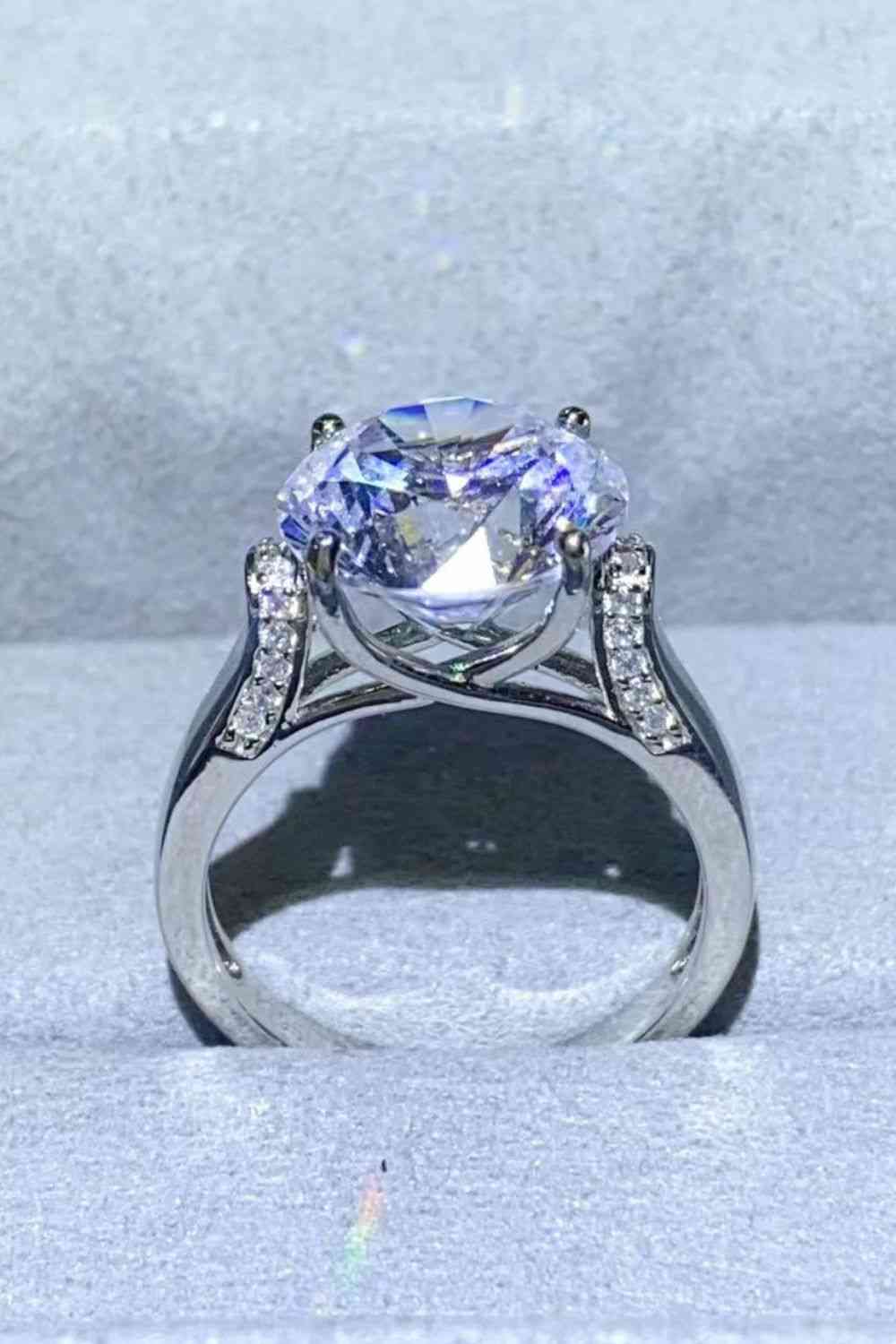 a diamond ring with a center stone surrounded by diamonds