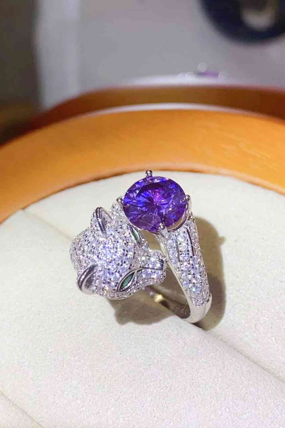 a close up of a ring with a purple stone