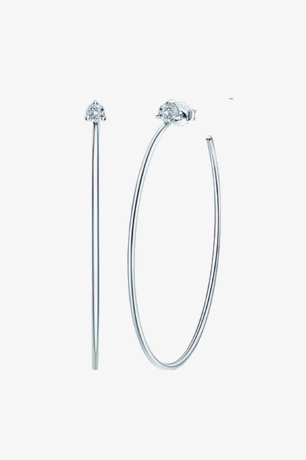 a pair of hoop earrings with a diamond on top