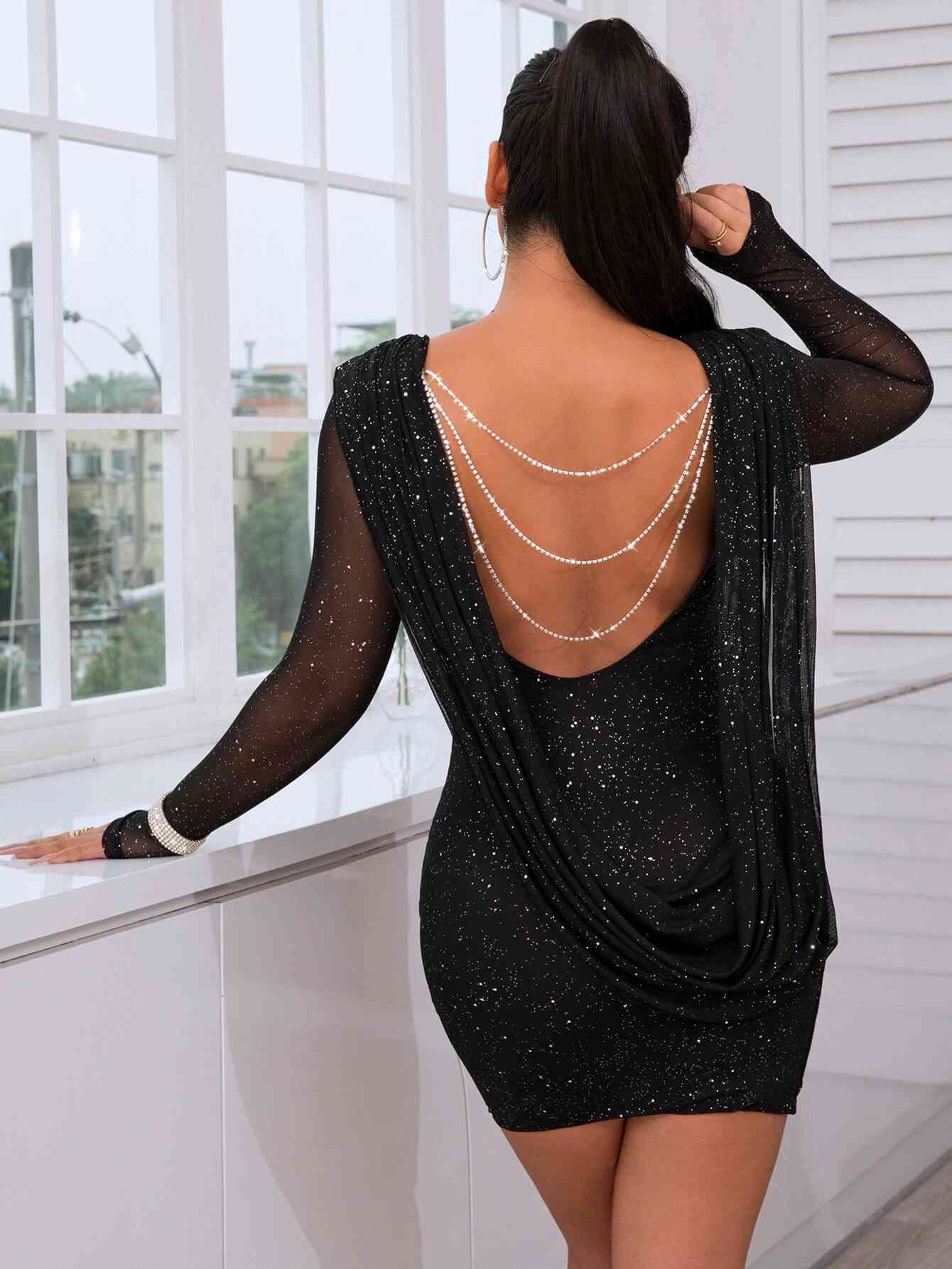 the back of a woman in a black dress