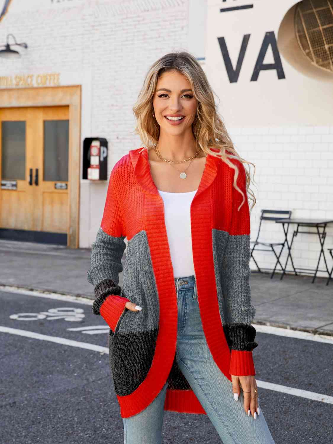 a woman wearing a red and grey cardigan