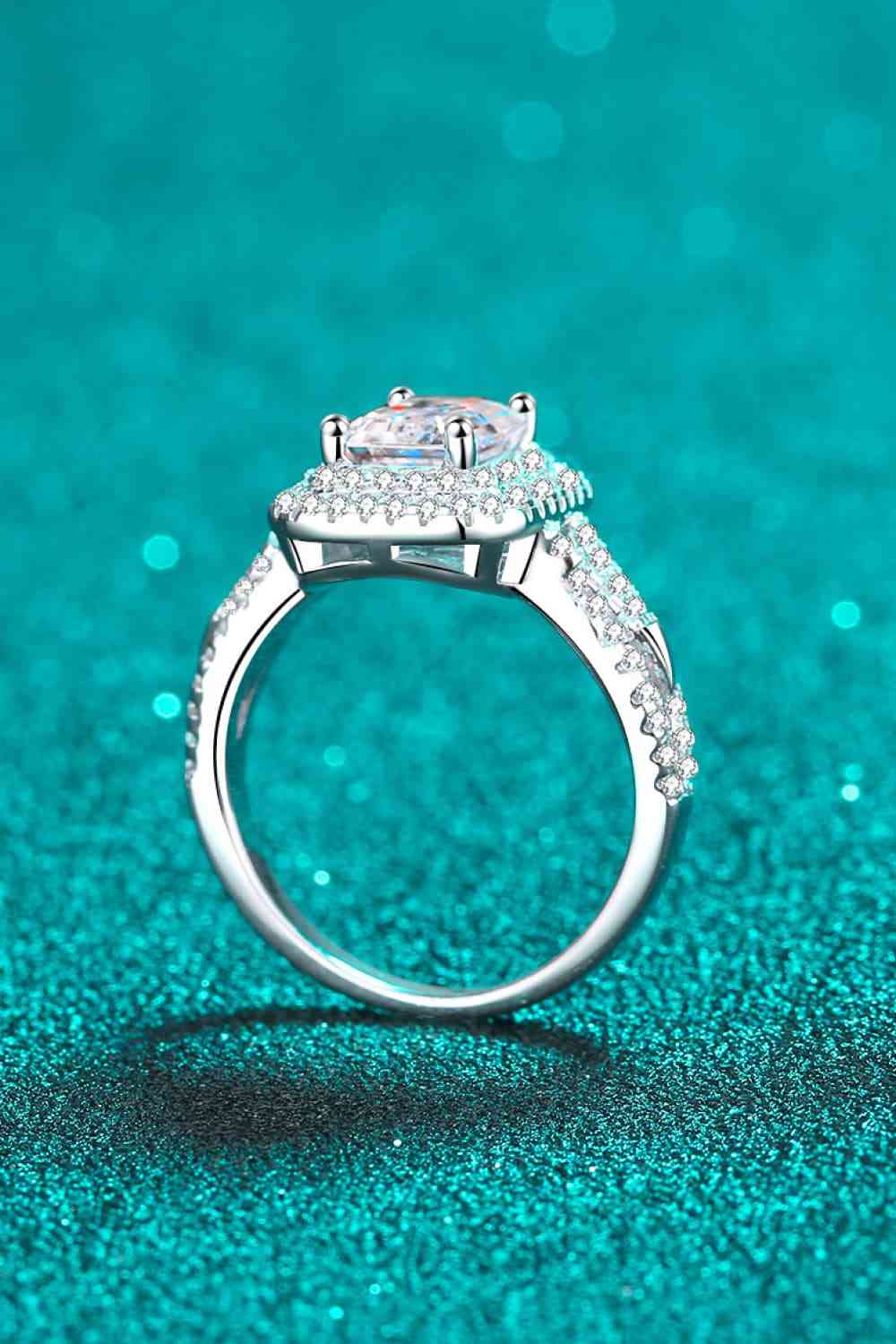 a close up of a diamond ring on a blue background