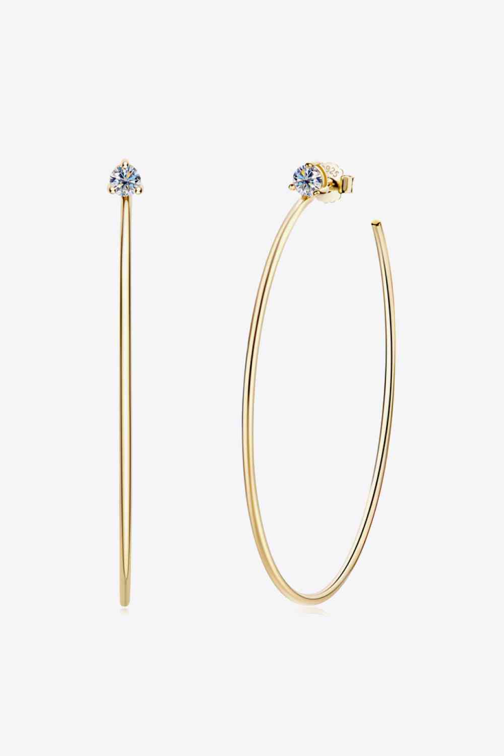 a pair of gold hoop earrings with a single diamond