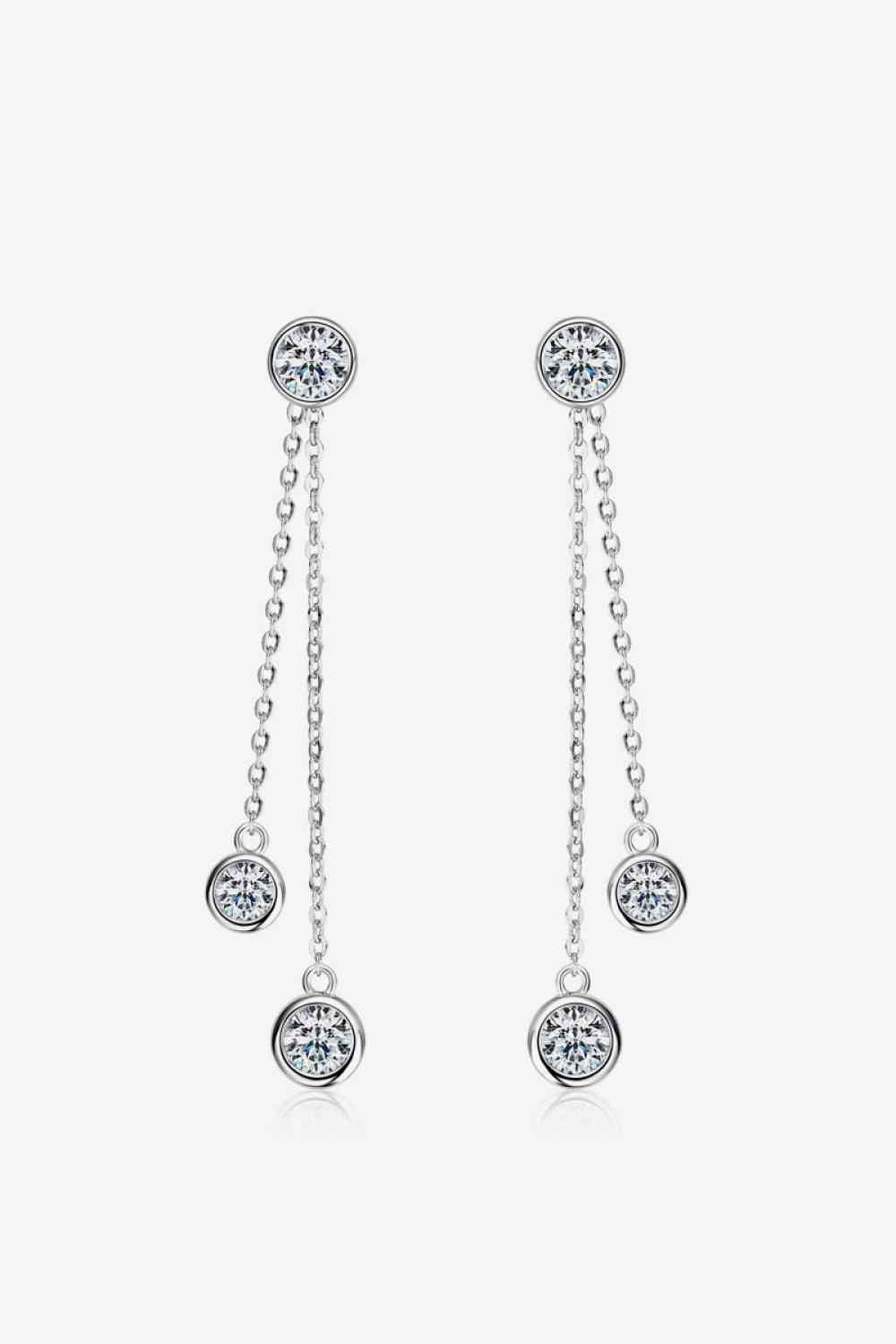 a pair of earrings with a dangling chain
