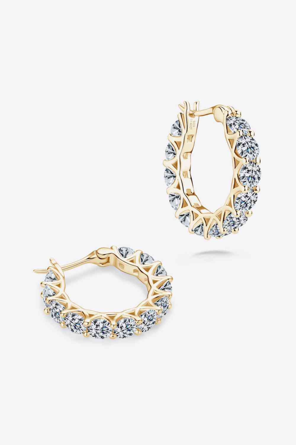 a pair of gold hoop earrings with crystal stones