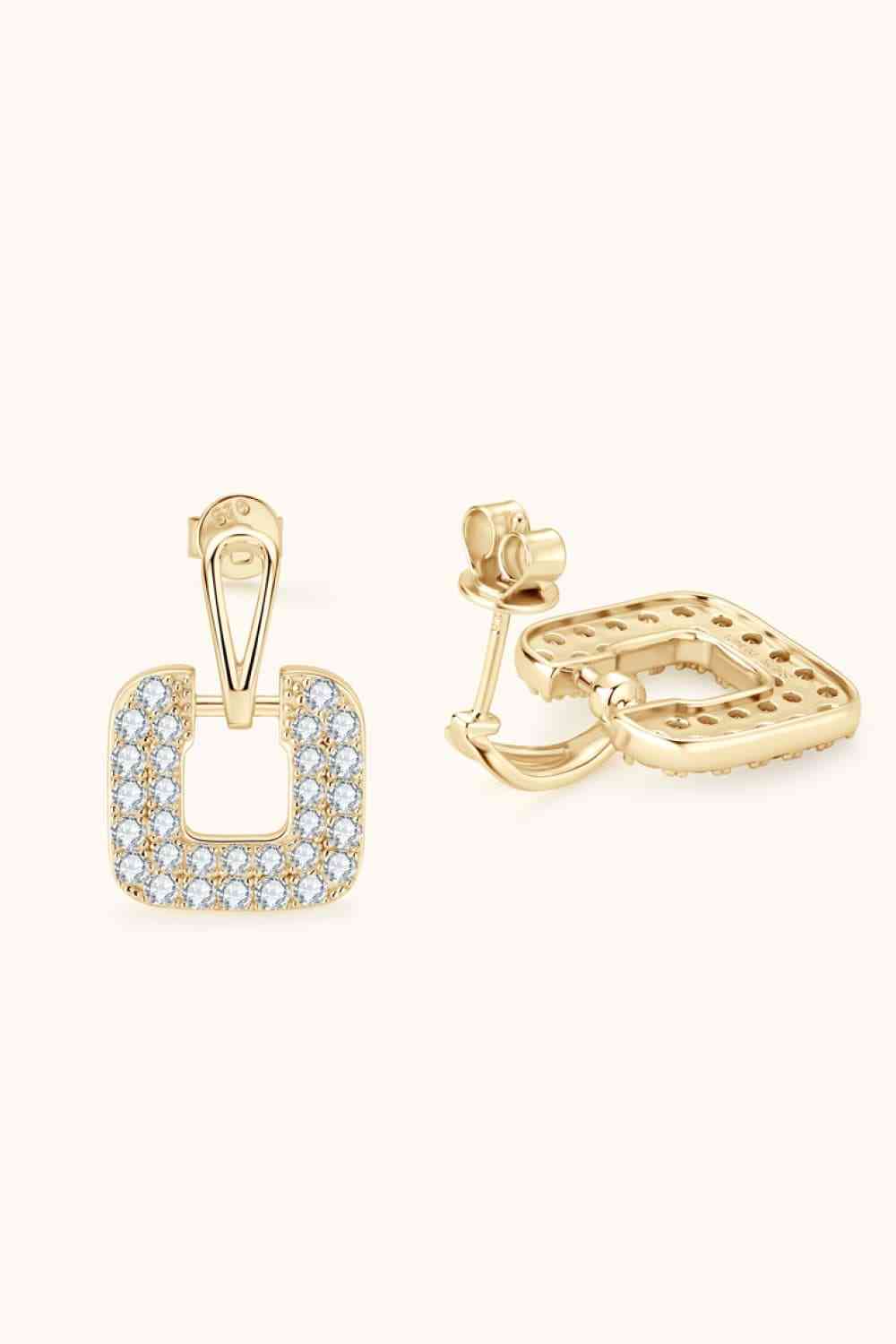 a pair of gold earrings with diamonds