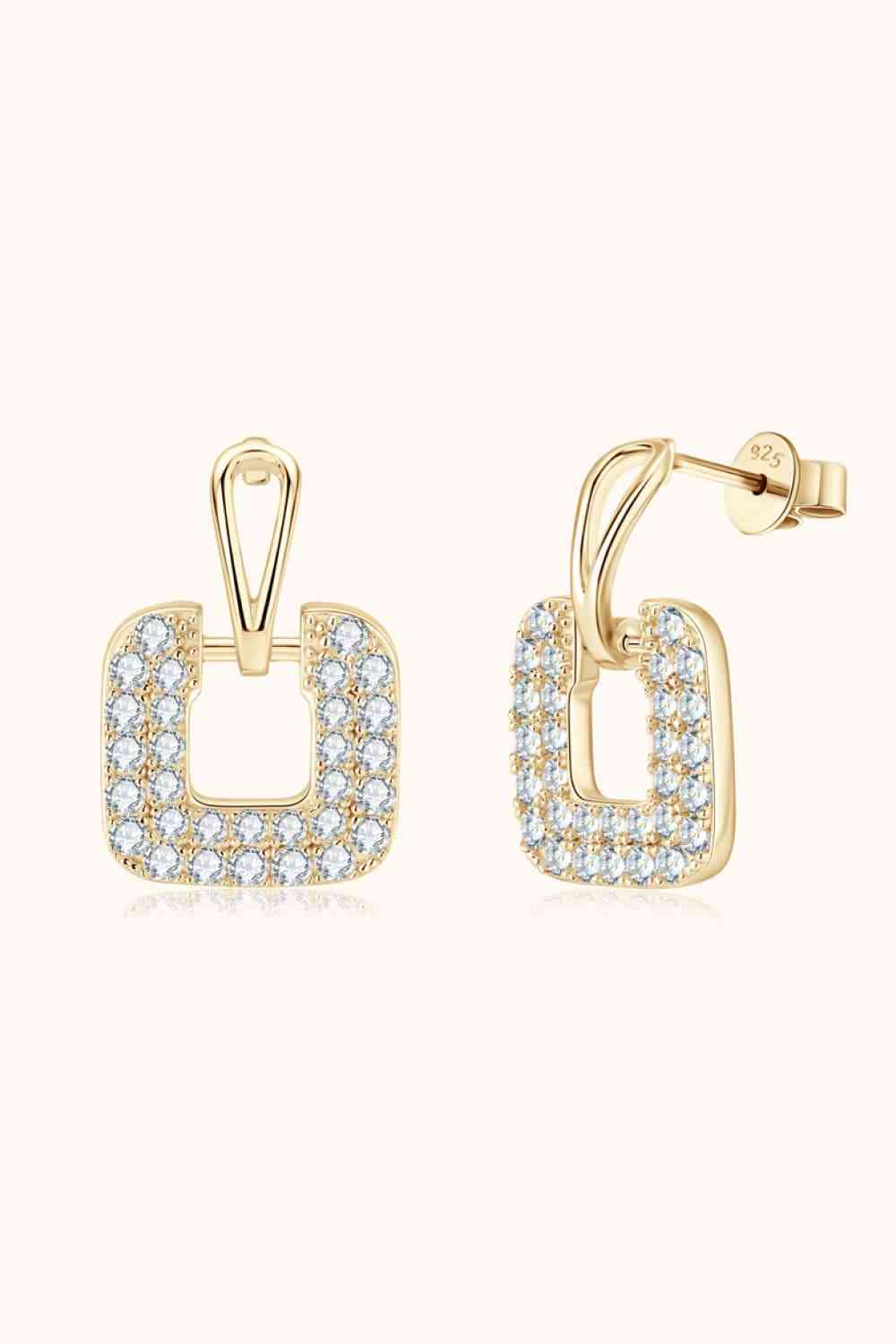a pair of gold earrings with white diamonds