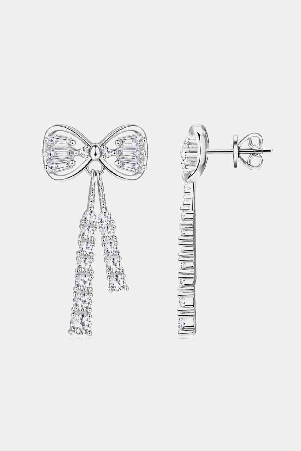a pair of earrings with a bow