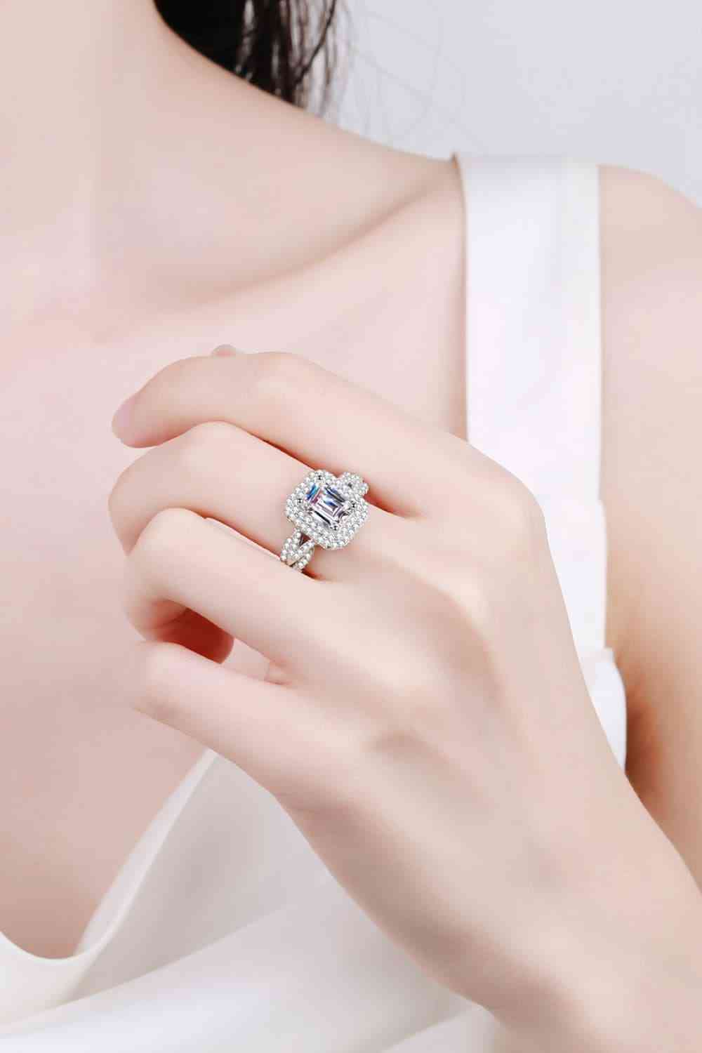 a woman wearing a ring with a diamond in it
