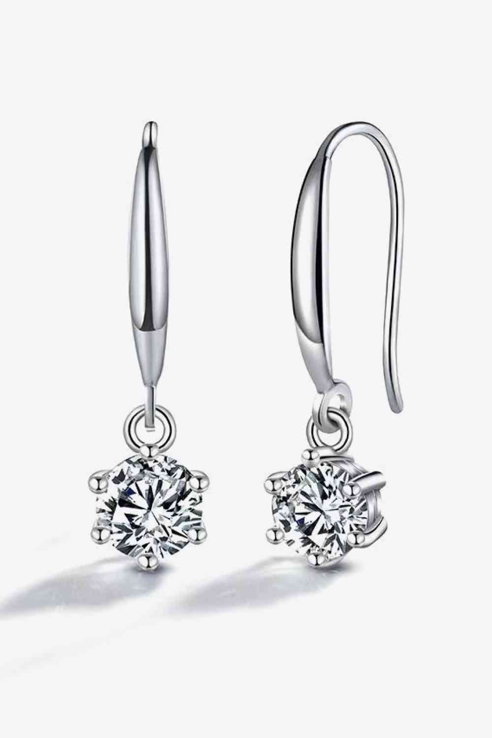 a pair of earrings with a diamond in the center