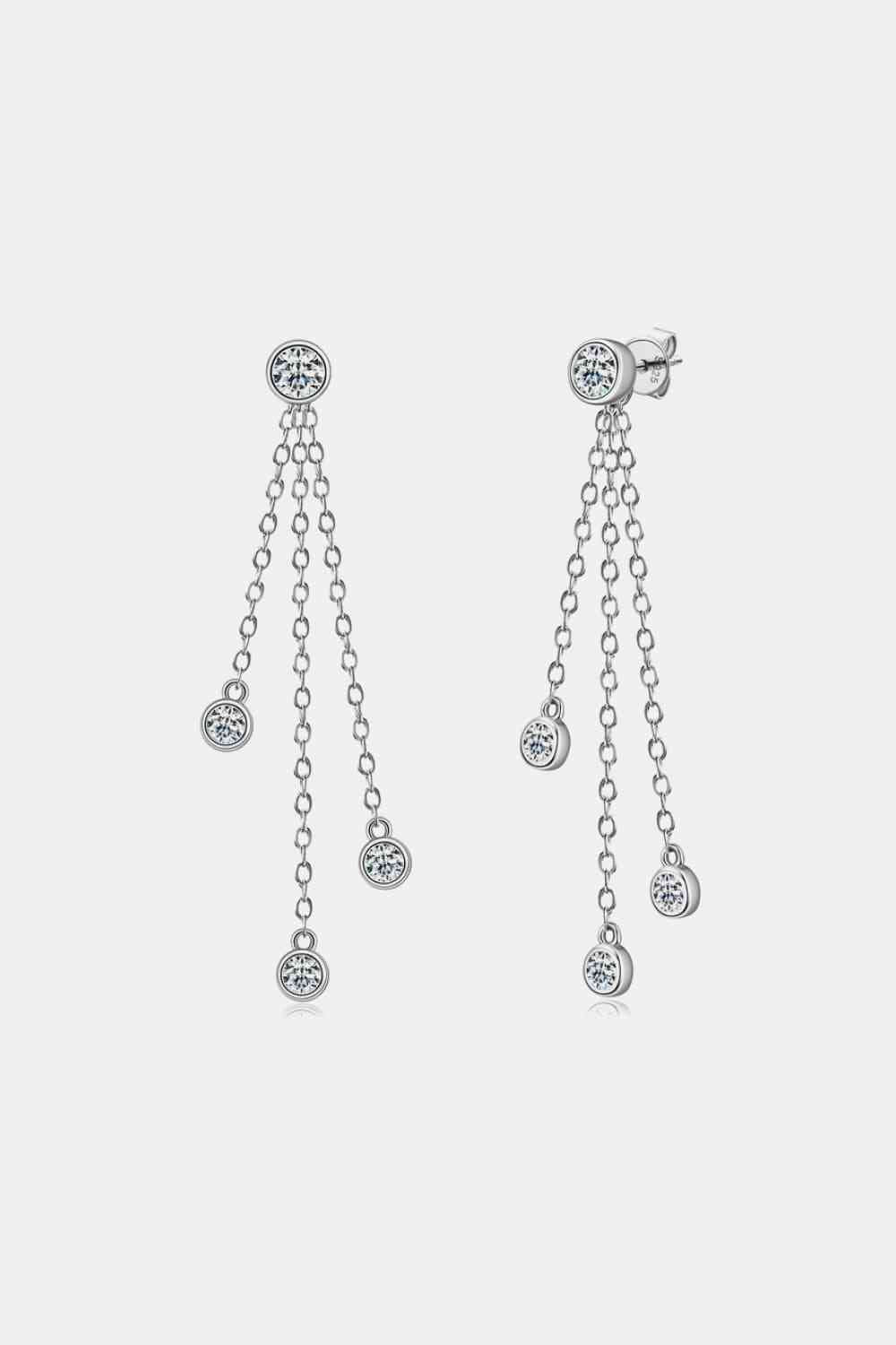 a pair of earrings with dangling chains