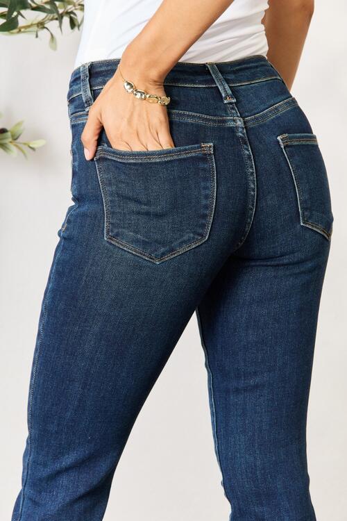 a woman in jeans with her hands in her pockets